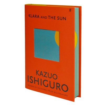 Picture of the cover of Kazuo Ishiguro's Klara and the Sun, on a red cover, a window of blue shows a sliver of the sun which is echoed in the sprayed edges of the pages to give the impression of the sun setting around the book.